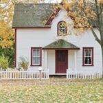 White and Red Wooden House With Fence